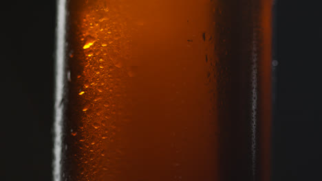 Close-Up-Of-Condensation-Droplets-On-Revolving-Bottle-Of-Cold-Beer-Or-Soft-Drink-3